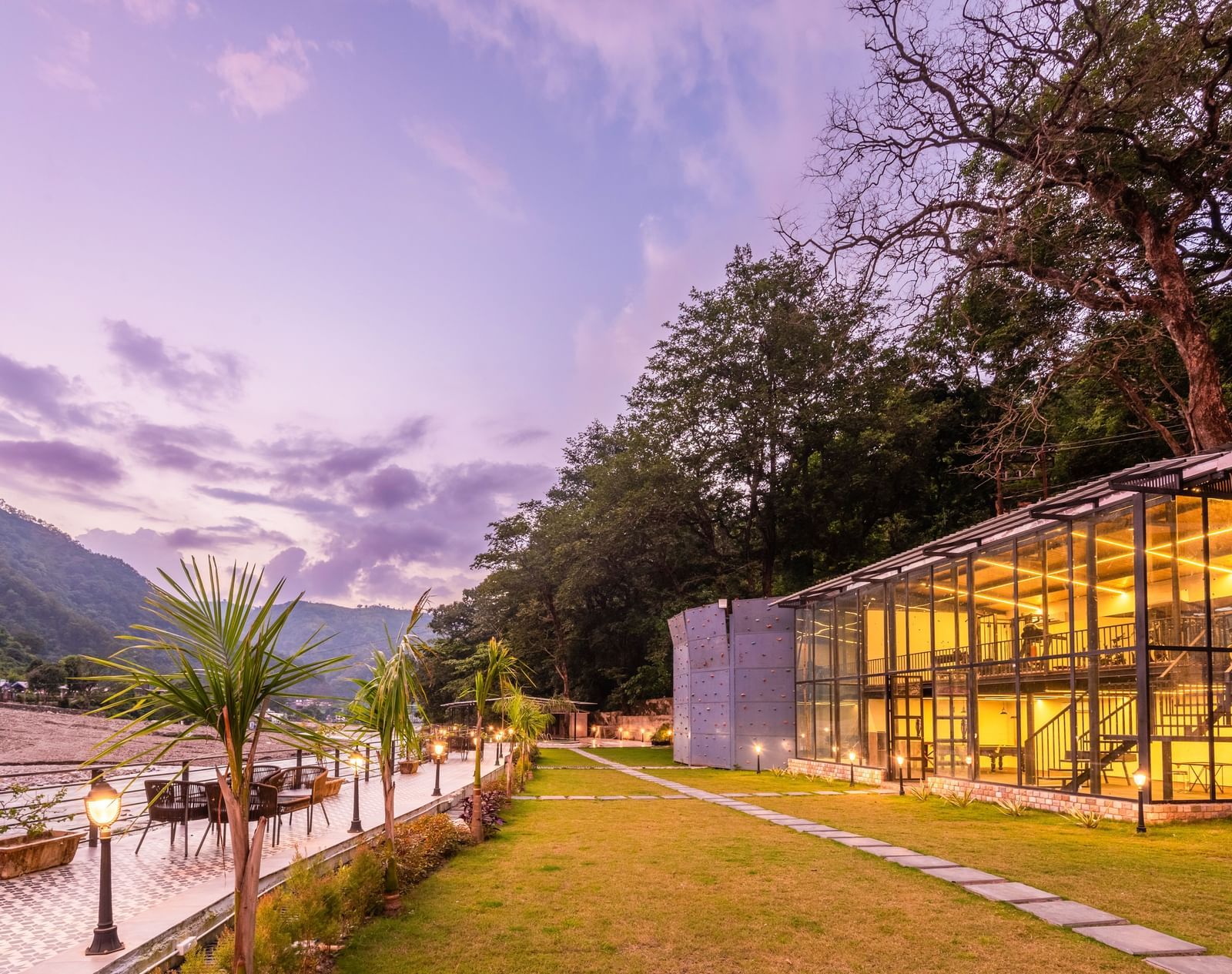 Exterior facade view of DLS Divine River Resort and Spa with stunning lighting and garden area taken in the evening 